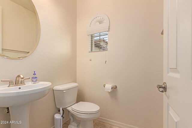 bathroom with tile patterned floors, sink, and toilet