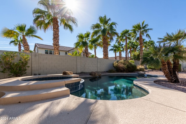 view of pool with an in ground hot tub