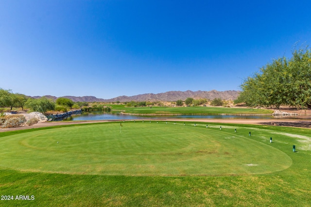 surrounding community with a water and mountain view