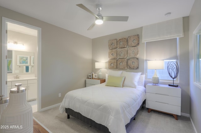 carpeted bedroom featuring connected bathroom and ceiling fan