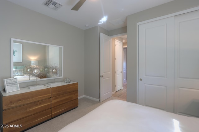 carpeted bedroom featuring ceiling fan and a closet