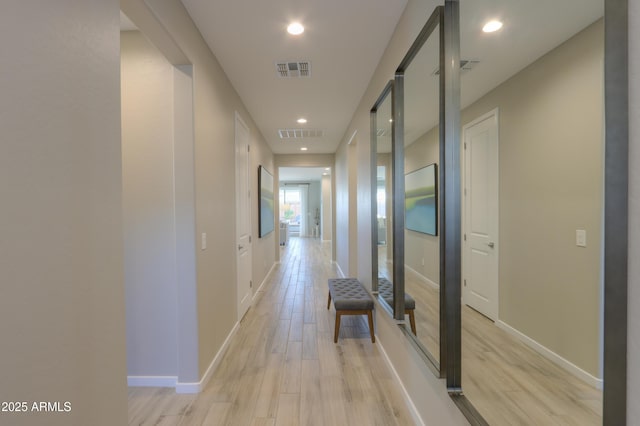 hallway with light hardwood / wood-style floors