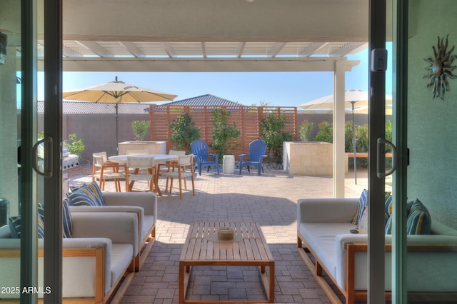 view of patio featuring an outdoor hangout area and a pergola