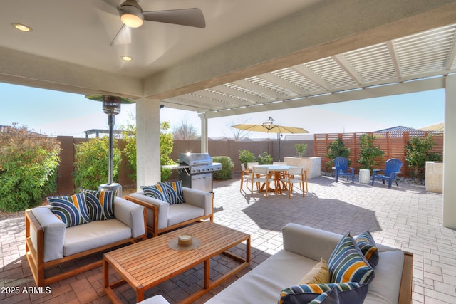 view of patio featuring an outdoor living space, grilling area, ceiling fan, and a pergola