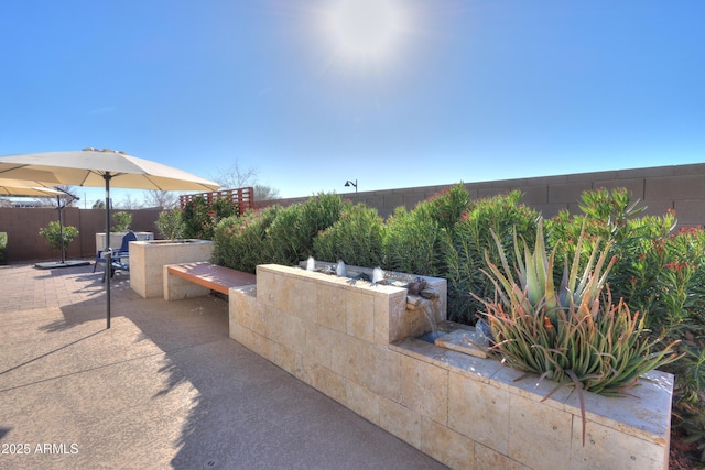 view of patio with an outdoor kitchen and an outdoor bar