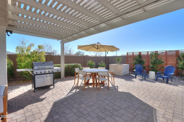 view of patio featuring grilling area and a pergola