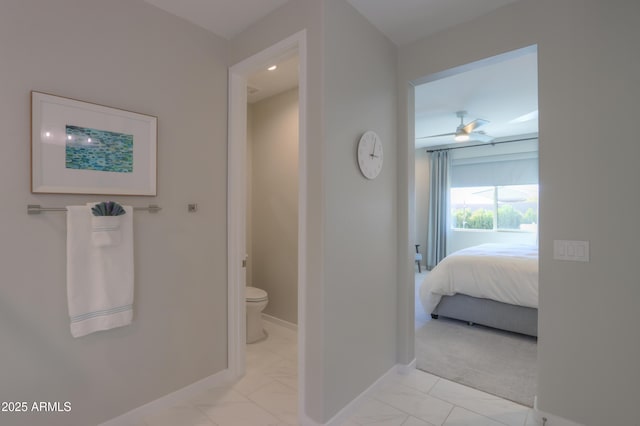 bathroom featuring ceiling fan and toilet