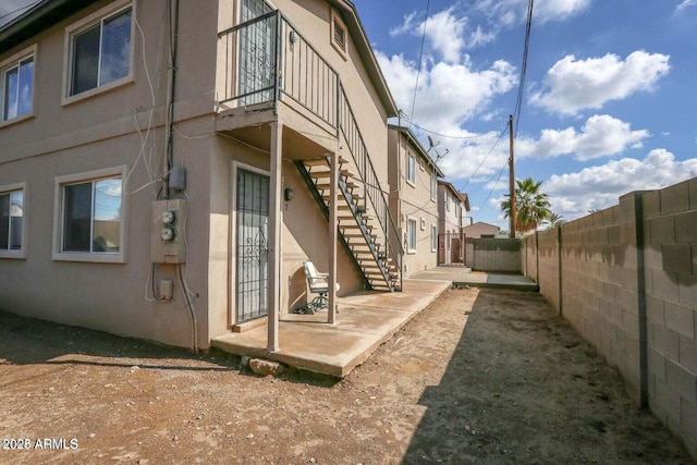 1321 W Vogel Ave, Phoenix, AZ 85021 - view of property exterior featuring a fenced backyard, stucco siding, stairway, and a patio