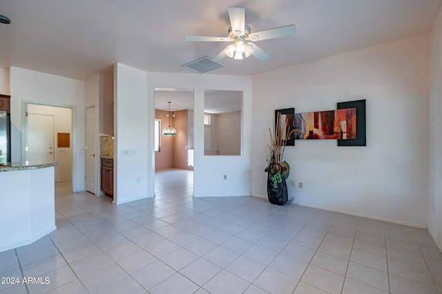 tiled spare room with ceiling fan