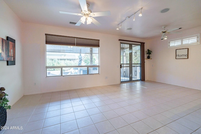 empty room featuring light tile patterned floors and ceiling fan