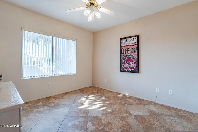 spare room with ceiling fan