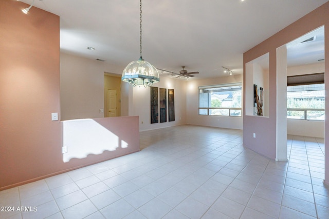 spare room featuring light tile patterned floors and ceiling fan