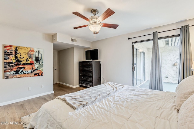 bedroom with visible vents, baseboards, wood finished floors, a ceiling fan, and access to outside