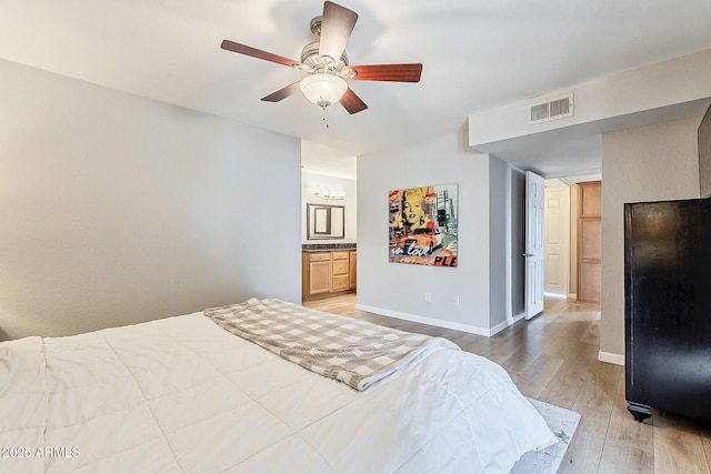 bedroom featuring visible vents, baseboards, ceiling fan, light wood-style flooring, and ensuite bath