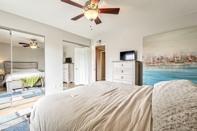 bedroom featuring wood finished floors, visible vents, and ceiling fan