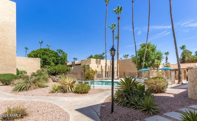 pool featuring a patio and fence