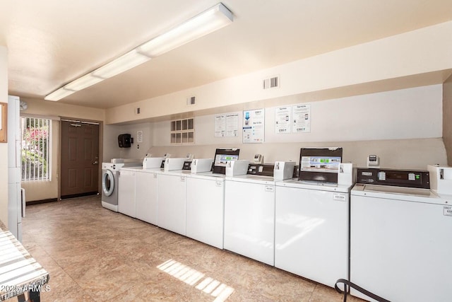 shared laundry area with visible vents and washing machine and clothes dryer