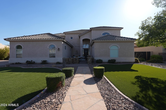 mediterranean / spanish-style house with a front yard