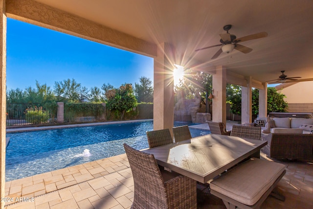 view of pool with a patio area, pool water feature, an outdoor hangout area, and ceiling fan