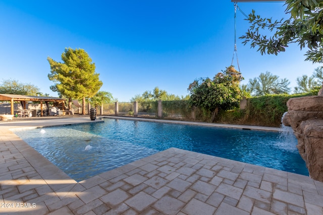 view of swimming pool featuring a patio and pool water feature