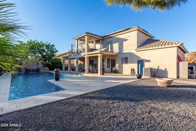 rear view of property featuring a patio area, central AC, and a balcony