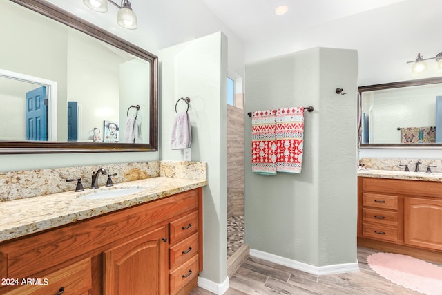 bathroom with vanity, walk in shower, and hardwood / wood-style floors