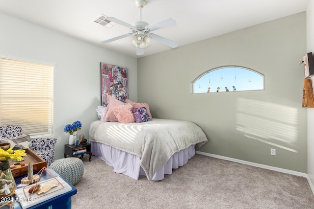 bedroom featuring light colored carpet and ceiling fan