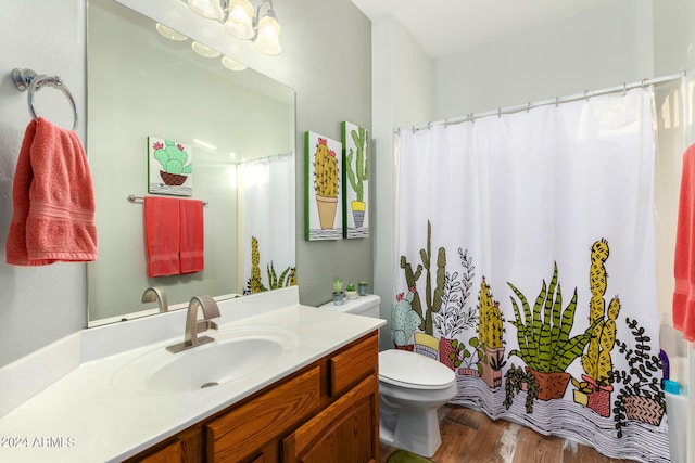 bathroom featuring toilet, vanity, wood-type flooring, and a shower with shower curtain