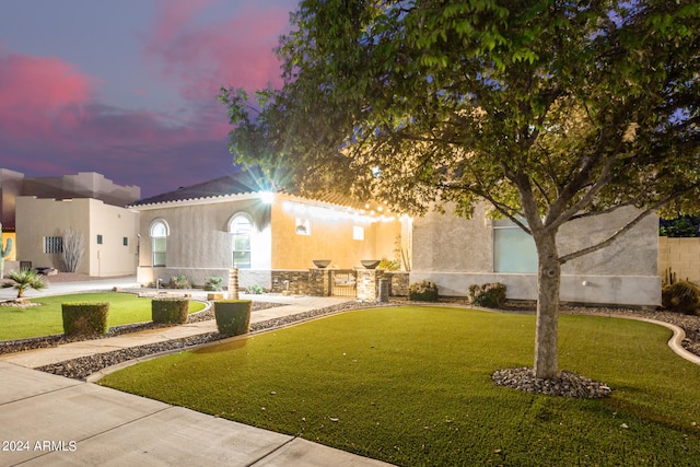 mediterranean / spanish-style home featuring a lawn