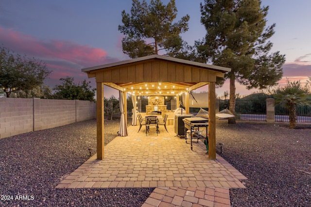 patio terrace at dusk featuring a gazebo