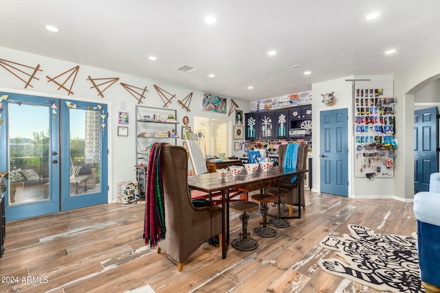 dining space featuring french doors and wood-type flooring