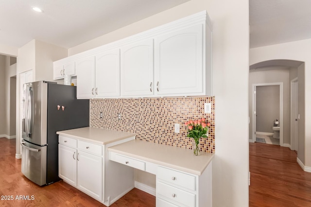 kitchen featuring white cabinetry, stainless steel fridge with ice dispenser, tasteful backsplash, and light hardwood / wood-style floors