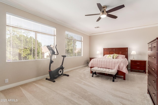 bedroom with ceiling fan, light colored carpet, and ornamental molding