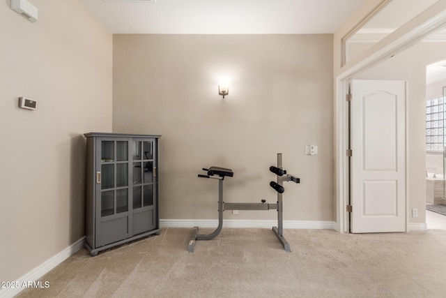 workout area featuring light carpet