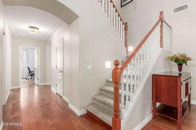 stairs featuring hardwood / wood-style floors