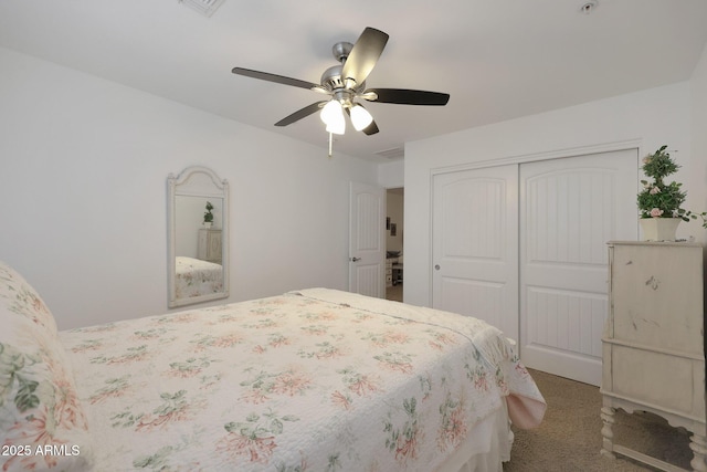 carpeted bedroom featuring a closet and a ceiling fan