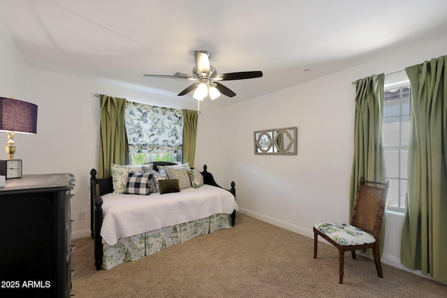 bedroom with ceiling fan, baseboards, and carpet floors