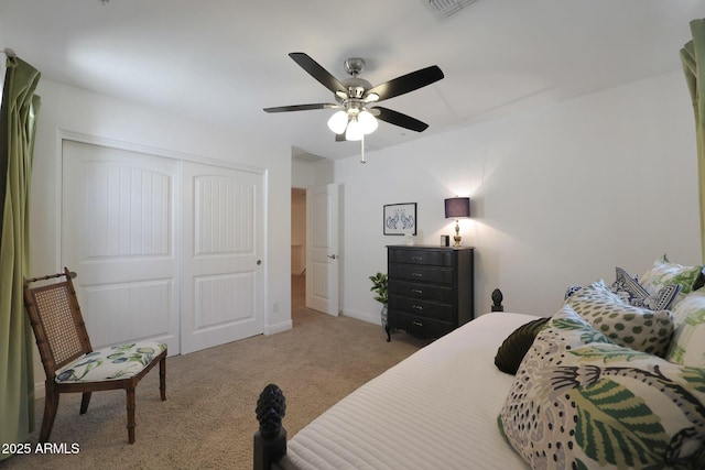 bedroom with visible vents, a ceiling fan, a closet, carpet flooring, and baseboards