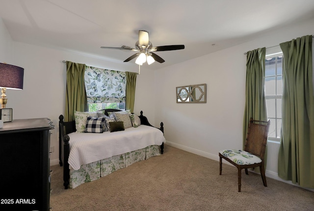 carpeted bedroom featuring baseboards and ceiling fan