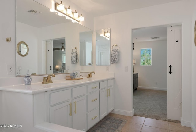full bath with tile patterned floors, double vanity, visible vents, and a sink