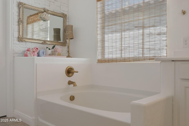 bathroom with a healthy amount of sunlight, a bath, and tile patterned flooring