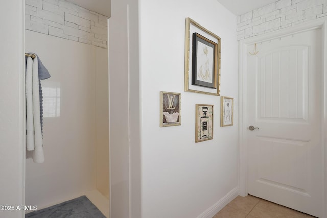 corridor featuring light tile patterned floors