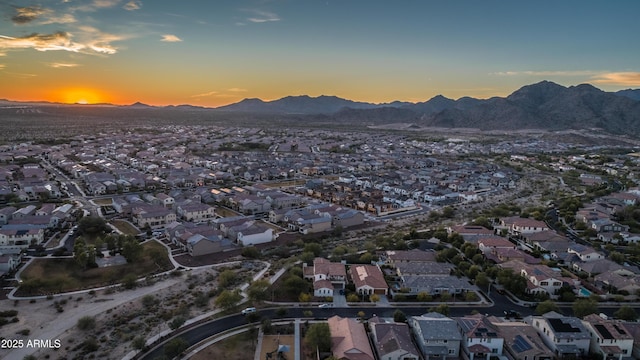 aerial view at dusk with a mountain view and a residential view