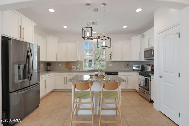 kitchen with light tile patterned floors, white cabinetry, and stainless steel appliances