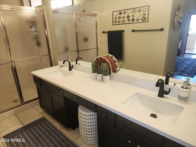 bathroom with vanity, tile patterned floors, and a shower with door