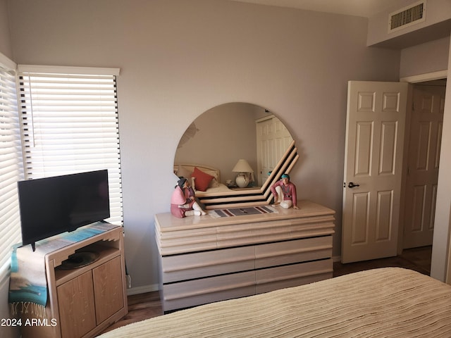 bedroom with dark hardwood / wood-style floors