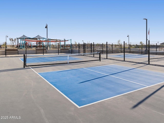 view of sport court with fence