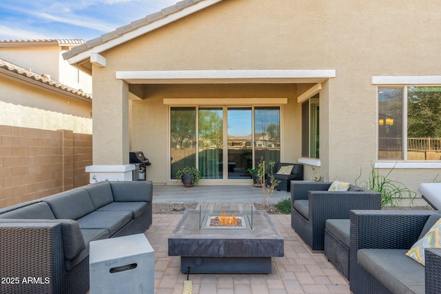 view of patio / terrace featuring area for grilling and an outdoor living space with a fire pit