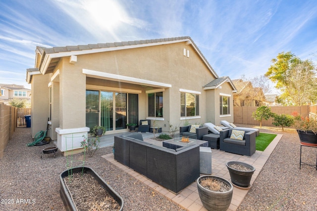 back of property with a patio area and an outdoor living space with a fire pit