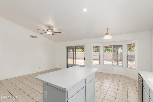 1371 W Gary Dr, Chandler, AZ 85224 - kitchen with lofted ceiling, a ceiling fan, light tile patterned floors, light countertops, and a kitchen island